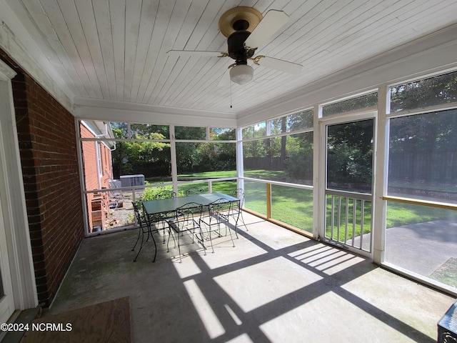 unfurnished sunroom featuring ceiling fan and wood ceiling