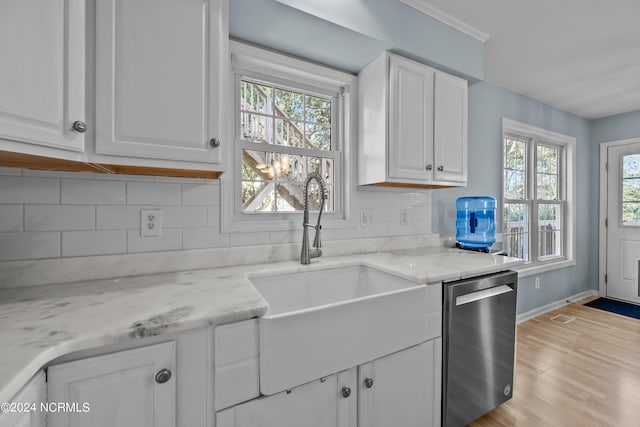 kitchen featuring a wealth of natural light, dishwasher, light hardwood / wood-style flooring, and white cabinets