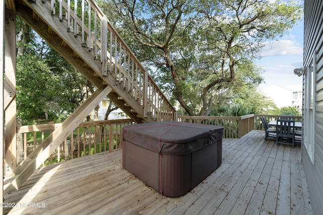 wooden terrace featuring a hot tub