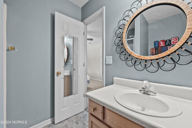 bathroom featuring a textured ceiling and vanity