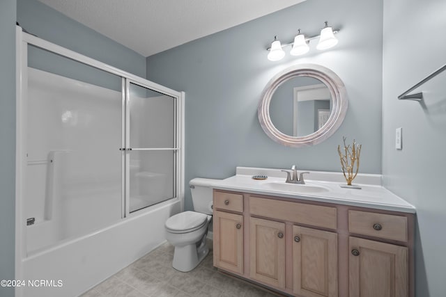 full bathroom with a textured ceiling, vanity, toilet, and bath / shower combo with glass door