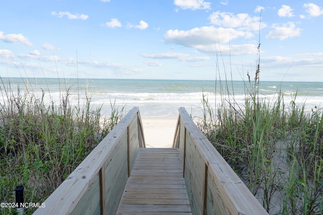 view of home's community featuring a beach view and a water view