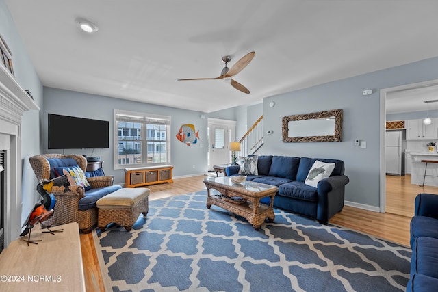 living room with ceiling fan and hardwood / wood-style flooring