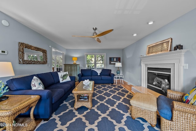 living room featuring hardwood / wood-style floors and ceiling fan