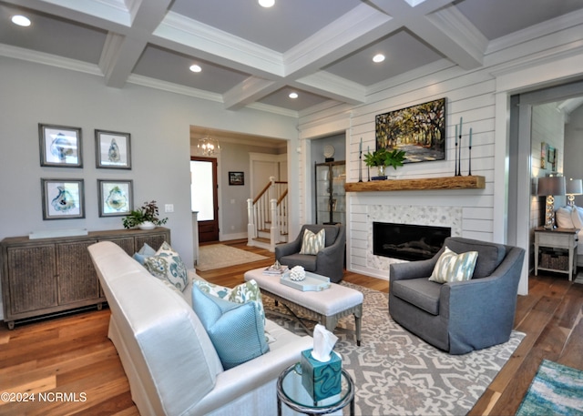 living room featuring a large fireplace, wood-type flooring, beam ceiling, and coffered ceiling