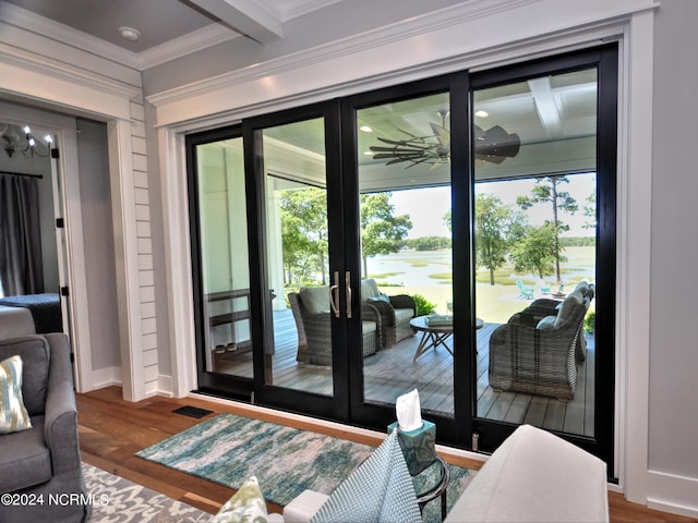 doorway with beamed ceiling, french doors, dark hardwood / wood-style floors, and crown molding