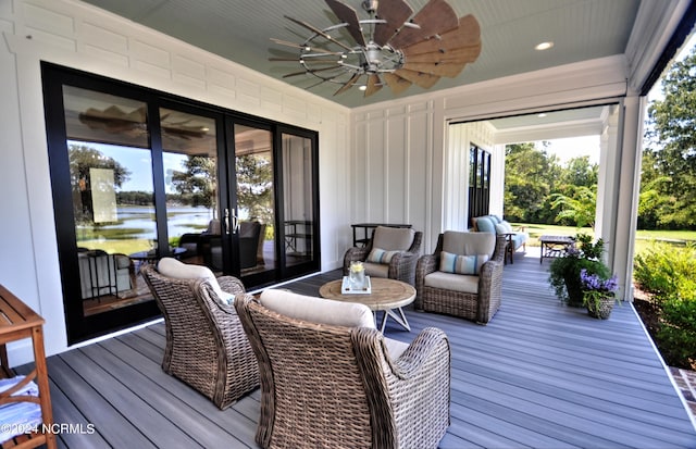 deck with an outdoor hangout area, a water view, and ceiling fan