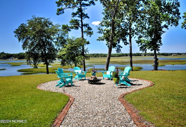 view of yard with a water view and a fire pit