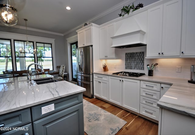 kitchen featuring sink, dark hardwood / wood-style floors, premium range hood, white cabinets, and appliances with stainless steel finishes