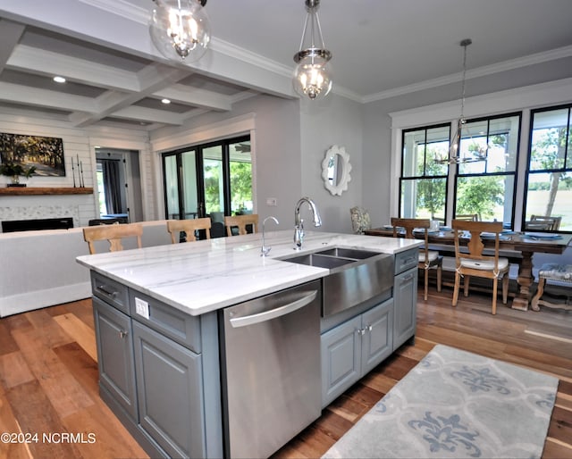 kitchen with gray cabinetry, dishwasher, a healthy amount of sunlight, and a center island with sink