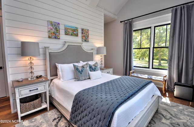 bedroom featuring dark hardwood / wood-style floors and lofted ceiling