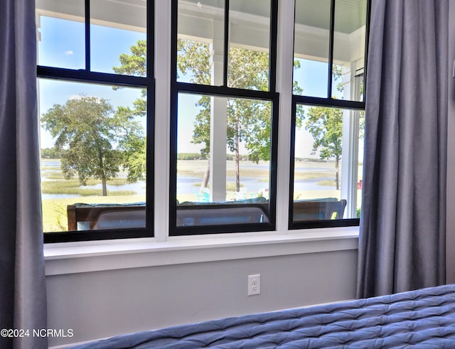 interior space with a water view and multiple windows