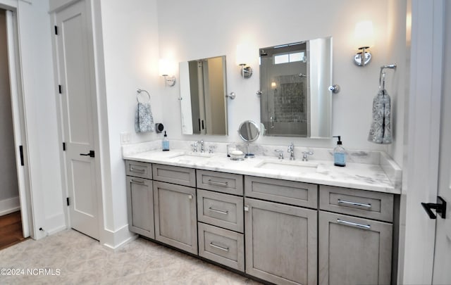 bathroom featuring tile patterned floors, vanity, and tiled shower