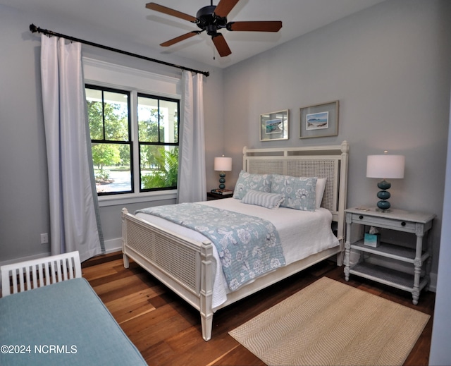 bedroom featuring radiator, ceiling fan, and dark wood-type flooring