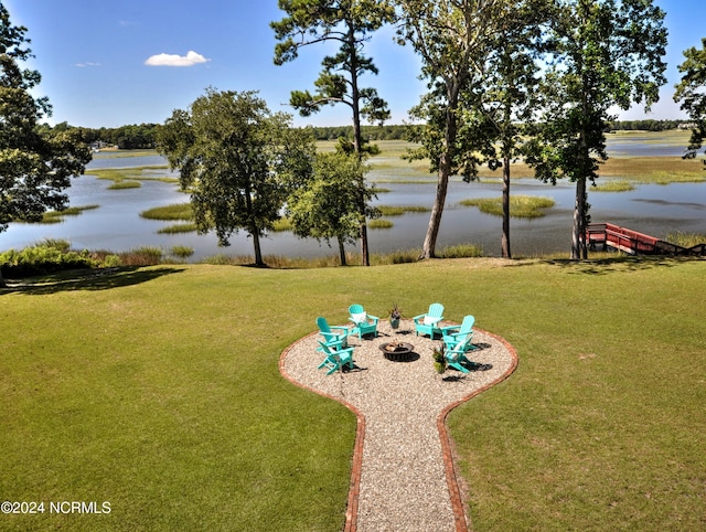 view of yard featuring a water view and a fire pit