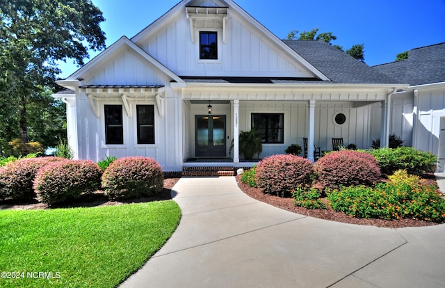 view of front of home featuring covered porch and french doors