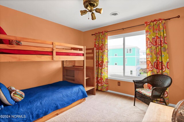 carpeted bedroom featuring baseboards and visible vents