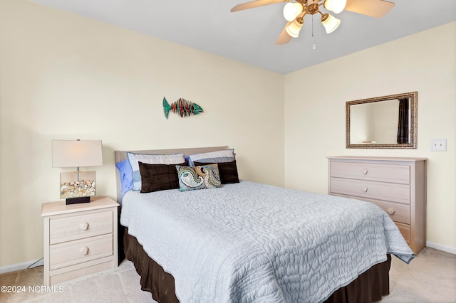 bedroom featuring baseboards, ceiling fan, and light colored carpet