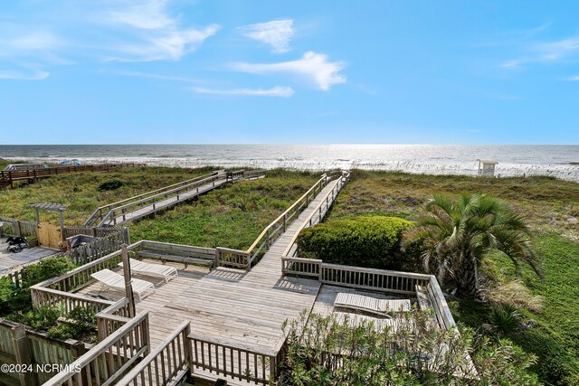 exterior space featuring a deck with water view