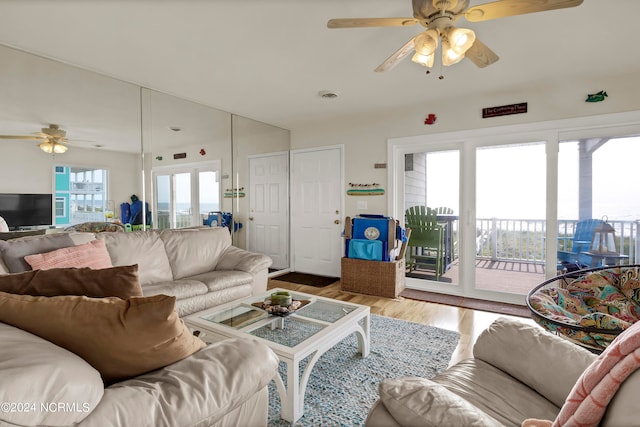 living room featuring ceiling fan, visible vents, and wood finished floors