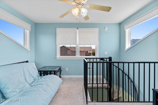 interior space with ceiling fan