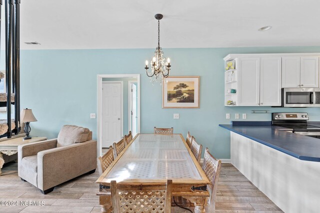 dining space with a chandelier and light hardwood / wood-style floors