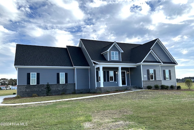 view of front of property with covered porch and a front yard