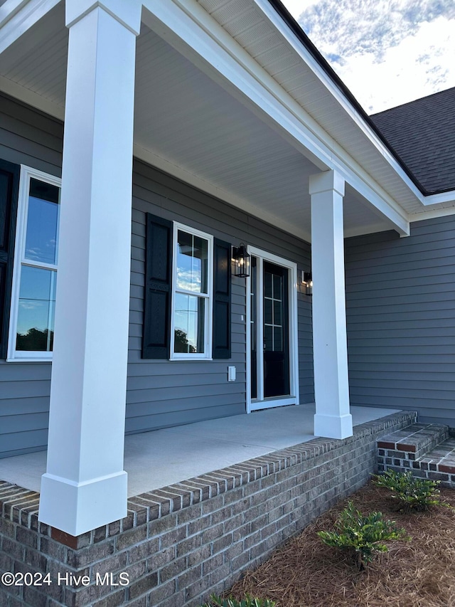 view of exterior entry featuring a porch