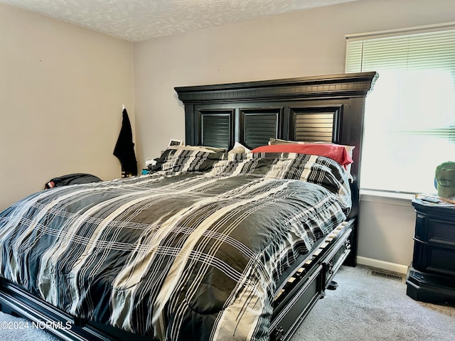 carpeted bedroom with a textured ceiling