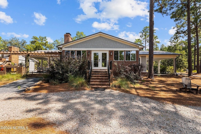 view of front of property with french doors and a pergola