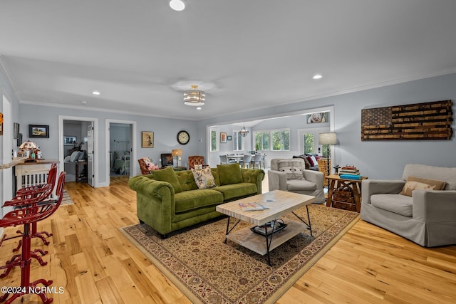 living room with ornamental molding and light wood-type flooring