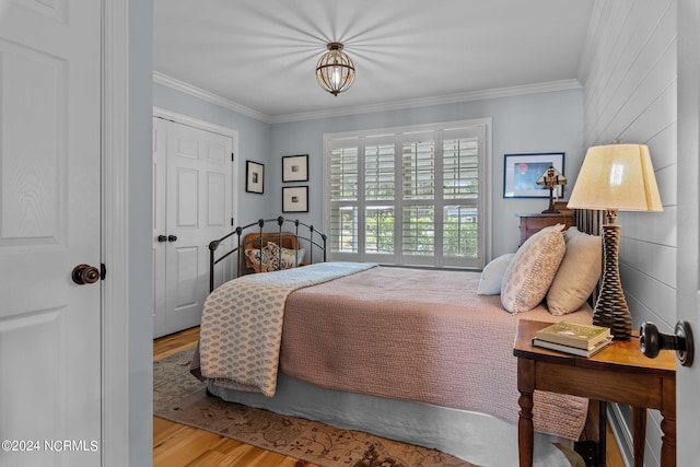 bedroom with crown molding and light hardwood / wood-style flooring