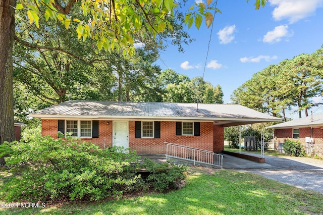 ranch-style house with a front lawn and a carport