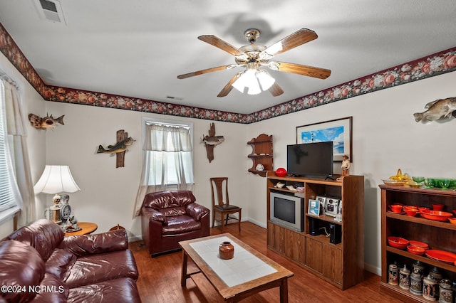 living room with dark wood-type flooring and ceiling fan