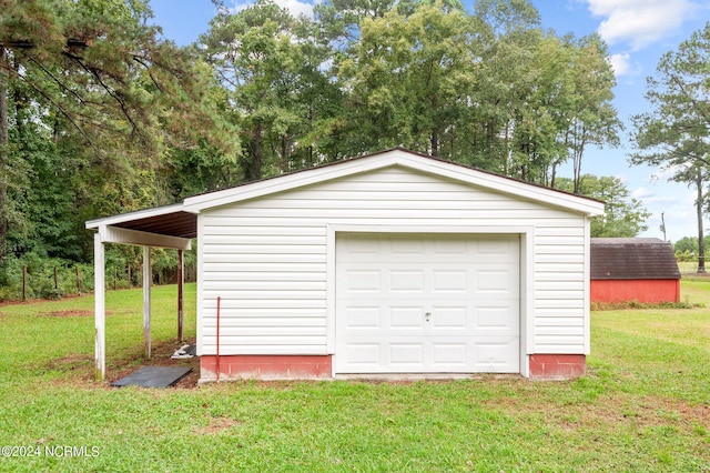 garage featuring a yard and a carport