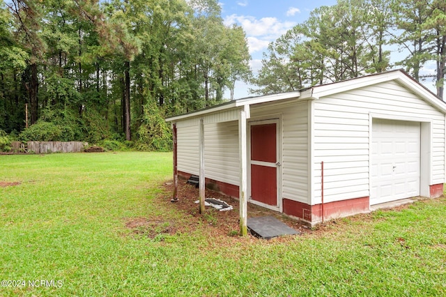 exterior space with a garage and a lawn