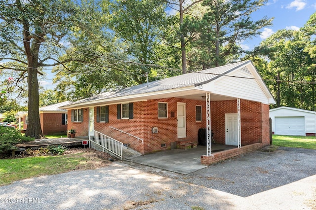 single story home with an outbuilding and a garage