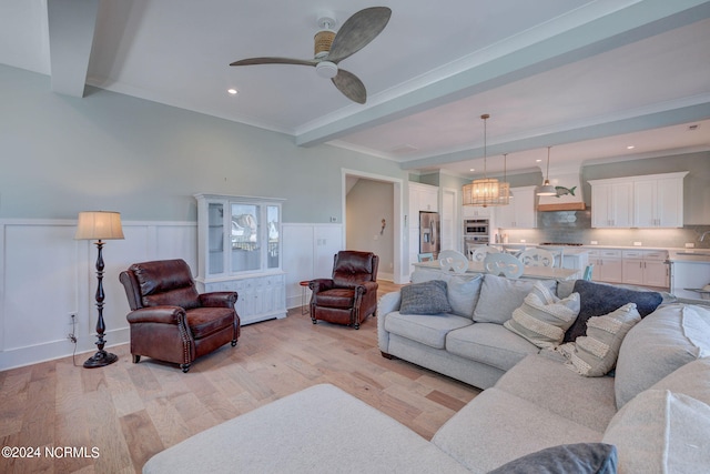 living room featuring ceiling fan with notable chandelier, light wood-type flooring, and beam ceiling