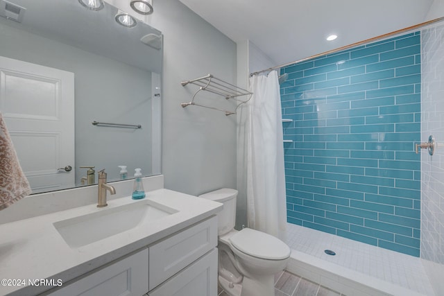 bathroom with a shower with shower curtain, toilet, and vanity