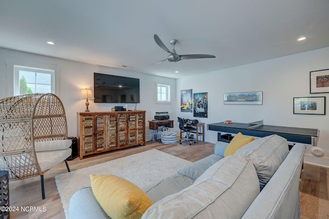 living room with ceiling fan and light hardwood / wood-style floors