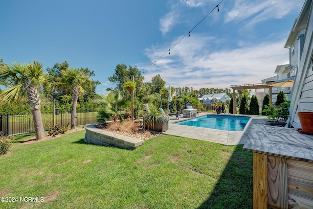 view of swimming pool with a lawn and a patio area