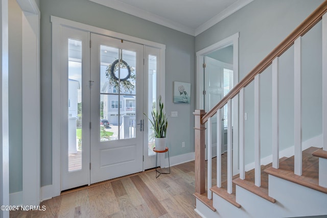 foyer with light hardwood / wood-style floors and crown molding