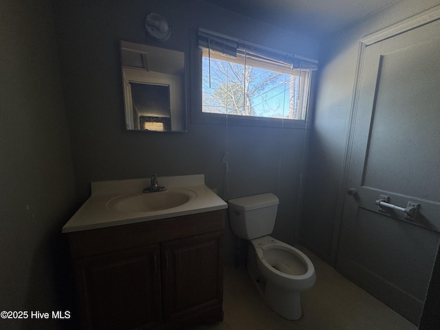 bathroom featuring toilet and vanity