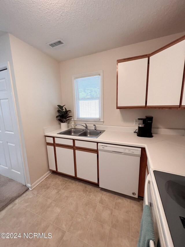 kitchen with dishwasher, white cabinetry, sink, stove, and a textured ceiling