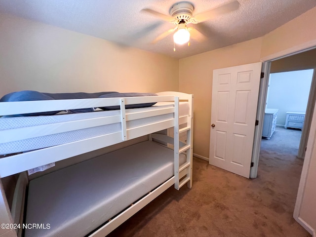 carpeted bedroom with a textured ceiling and ceiling fan