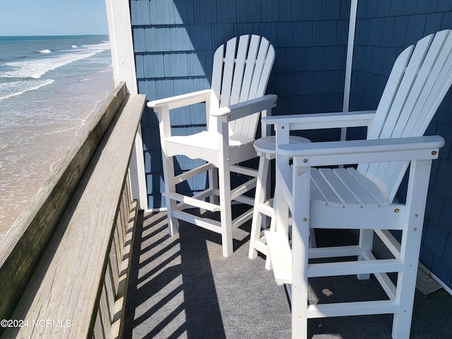 view of patio / terrace featuring a view of the beach and a water view