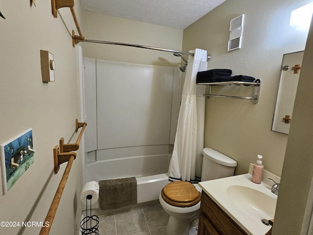 full bathroom with tile patterned flooring, vanity, a textured ceiling, toilet, and shower / bath combo with shower curtain