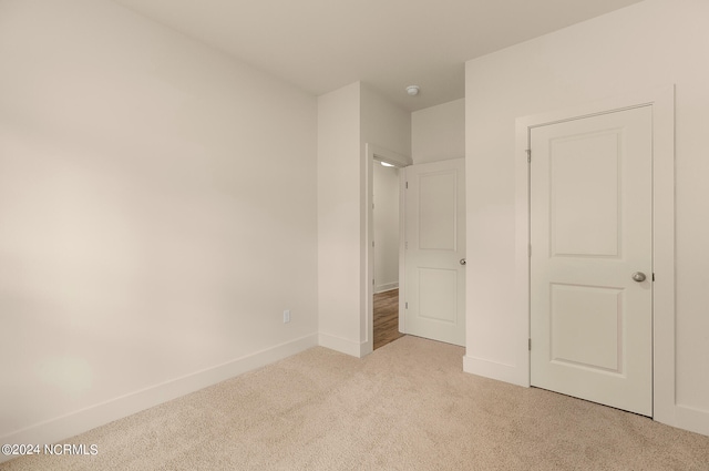 unfurnished bedroom featuring light colored carpet