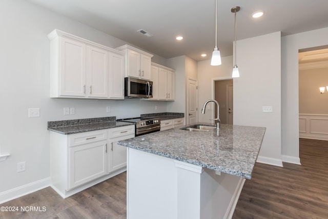 kitchen featuring sink, white cabinets, hanging light fixtures, and appliances with stainless steel finishes