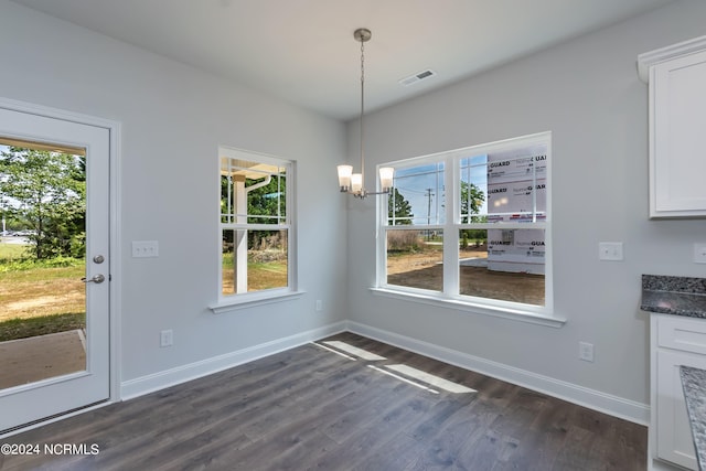 unfurnished dining area featuring dark hardwood / wood-style flooring and plenty of natural light